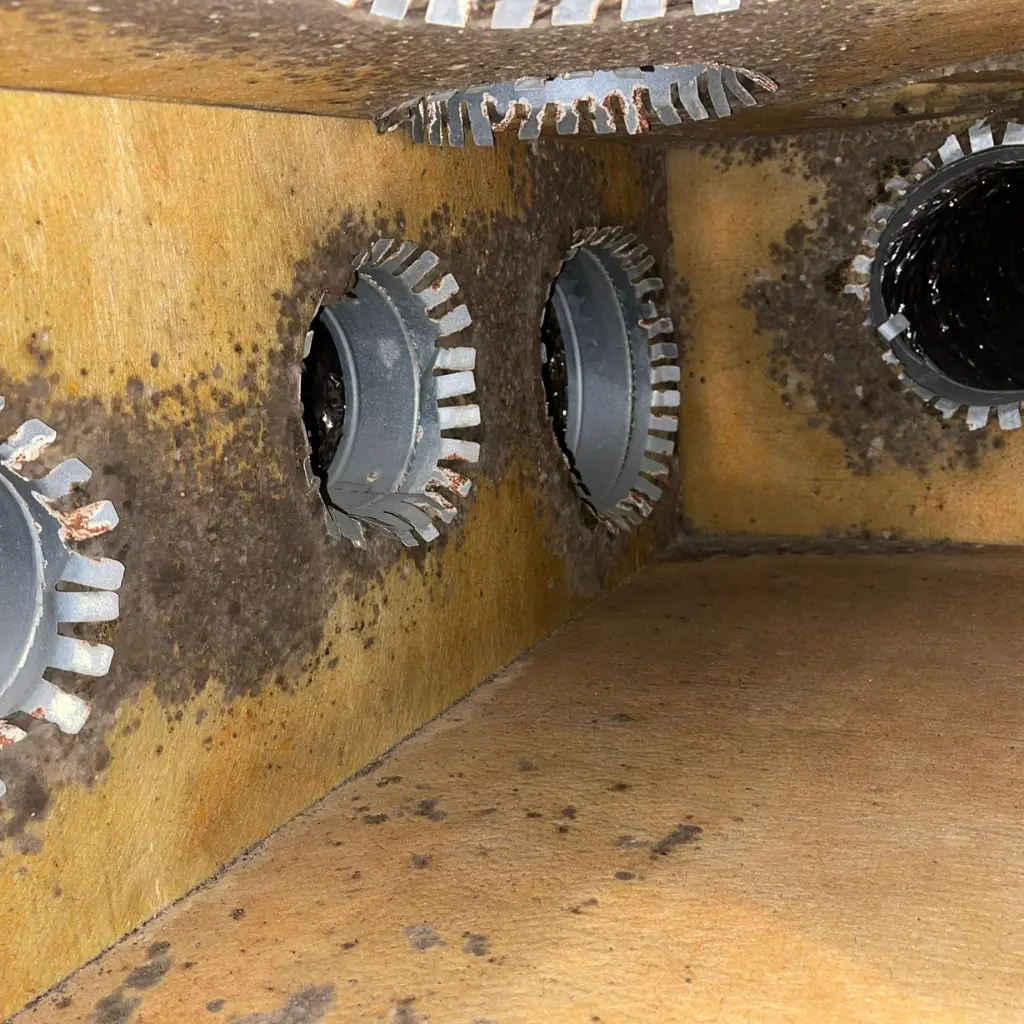 Before air duct cleaning in Austin showing heavy dust buildup